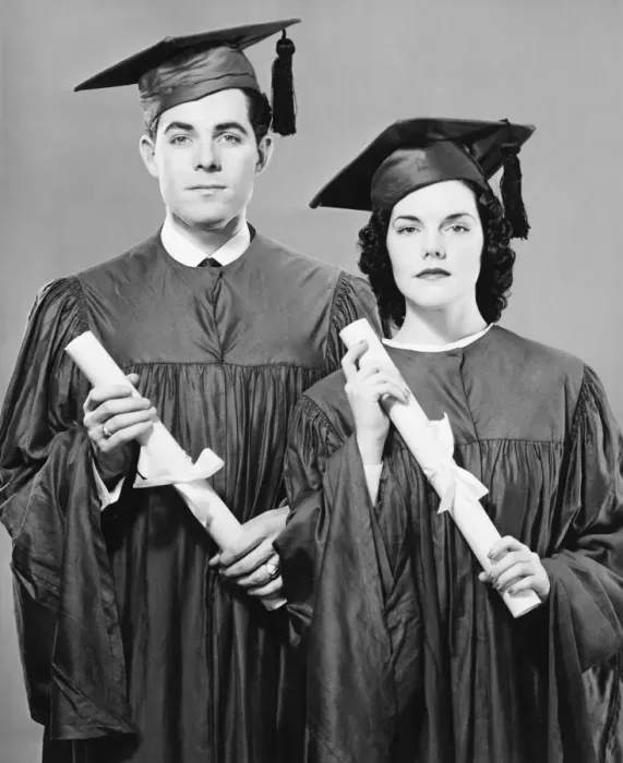 Framed Print : Young couple in graduate dress holding diplomas, posing in studio, (B&W), portrait Framed Print : Young couple in graduate dress holding diplomas, posing in studio, (B&W), portrait