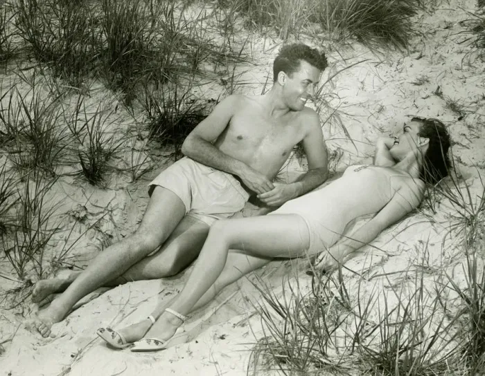 Framed Print : Young couple lying on sand, (B&W), elevated view Framed Print : Young couple lying on sand, (B&W), elevated view