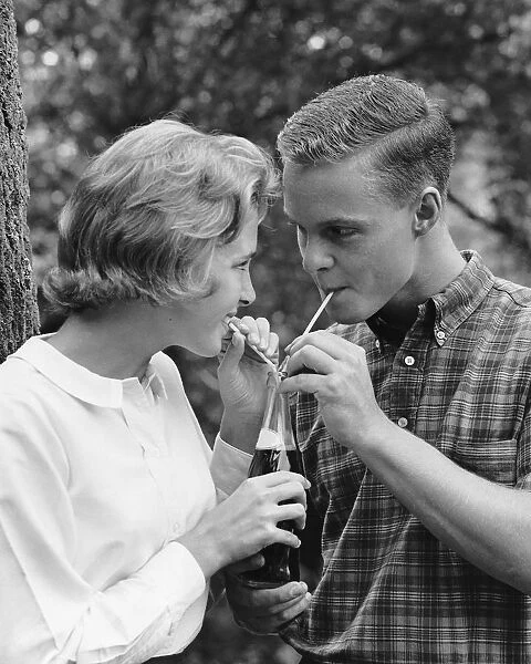 Young couple sharing soda