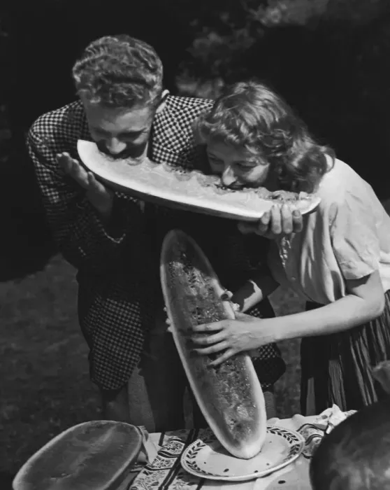 Framed Print : Young couple sharing wedge of watermelon (B&W) Framed Print : Young couple sharing wedge of watermelon (B&W)