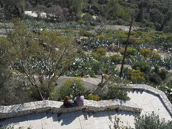 Young Couple Sitting Along The Stairway To Lycabettus Hill in Athens