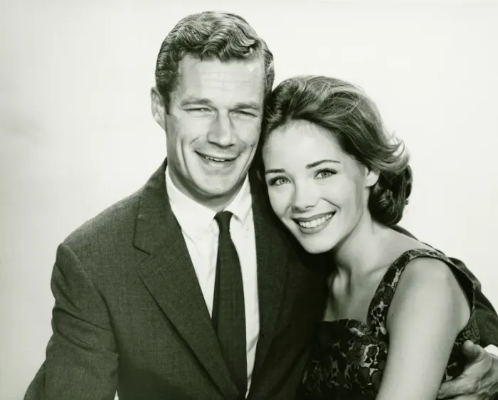 Framed Print : Young couple smiling, posing in studio, (B&W), portrait Framed Print : Young couple smiling, posing in studio, (B&W), portrait