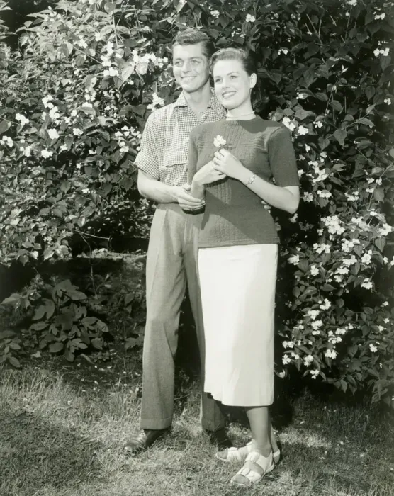 Framed Print : Young couple standing in garden Framed Print : Young couple standing in garden