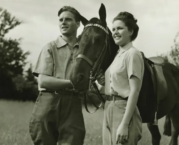 Framed Print : Young couple standing with horse in field, (B&W) Framed Print : Young couple standing with horse in field, (B&W)