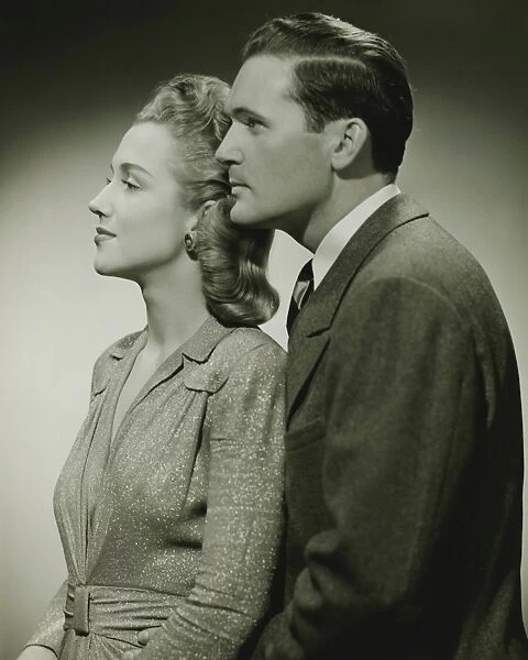 Young couple in studio, (B&W), close-up