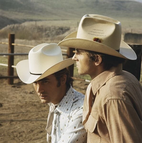 Young cowboys standing in ranch, close-up