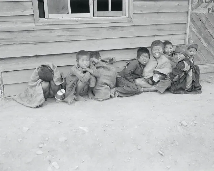 Framed Print : Young Distraught Koreans Resting Together in War Torn City Framed Print : Young Distraught Koreans Resting Together in War Torn City