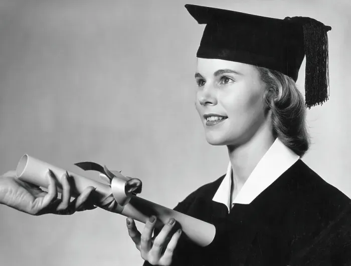 Framed Print : Young female graduate receiving diploma with ribbon around it Framed Print : Young female graduate receiving diploma with ribbon around it