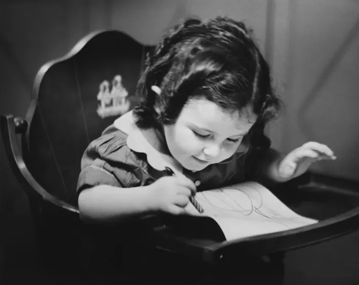 Framed Print : Young girl (2-3) in baby seat drawing, (B&W), close-up Framed Print : Young girl (2-3) in baby seat drawing, (B&W), close-up