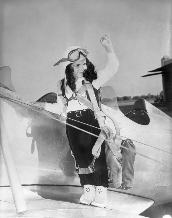 Framed Print : Young girl (8-9) standing on aeroplane wing Framed Print : Young girl (8-9) standing on aeroplane wing