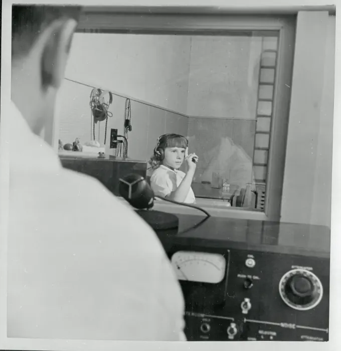 Framed Print : Young Hearing Impaired Girl Gesturing from Soundproof Room Framed Print : Young Hearing Impaired Girl Gesturing from Soundproof Room