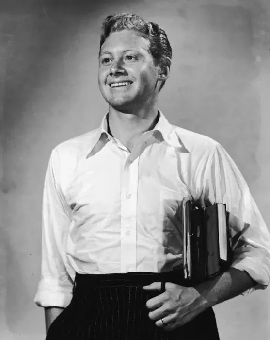 Framed Print : Young man with books under arm smiling (B&W) Framed Print : Young man with books under arm smiling (B&W)
