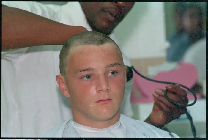 Framed Print : Young Man Getting Hair Shaved Off Framed Print : Young Man Getting Hair Shaved Off