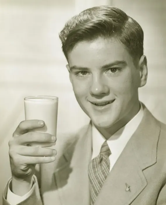 Framed Print : Young man holding glass of milk, (B&W), portrait Framed Print : Young man holding glass of milk, (B&W), portrait