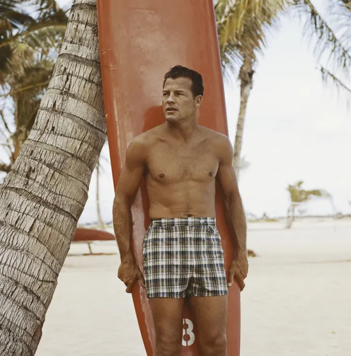 Framed Print : Young man holding surfboard on beach Framed Print : Young man holding surfboard on beach