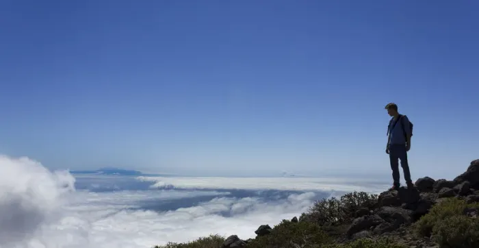 Framed Print : Young man looking across a layer of clouds, La Palma, Canary Islands, Spain Framed Print : Young man looking across a layer of clouds, La Palma, Canary Islands, Spain