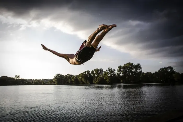 Framed Print : A young man plunging into water from the riverside, Germany Framed Print : A young man plunging into water from the riverside, Germany