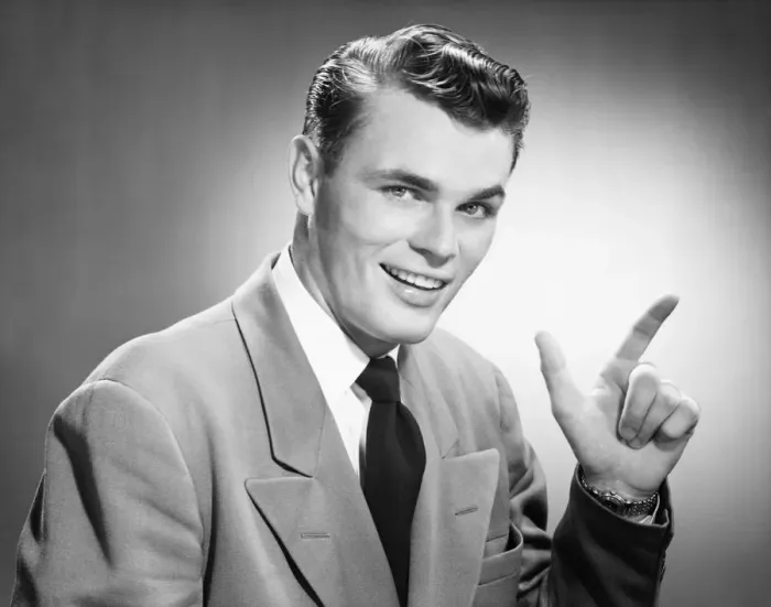 Framed Print : Young man pointing in studio, (B&W), (Close-up), (Portrait) Framed Print : Young man pointing in studio, (B&W), (Close-up), (Portrait)