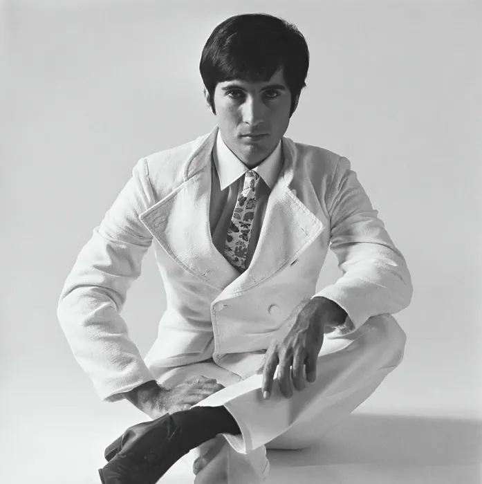 Framed Print : Young man sitting on white background, portrait