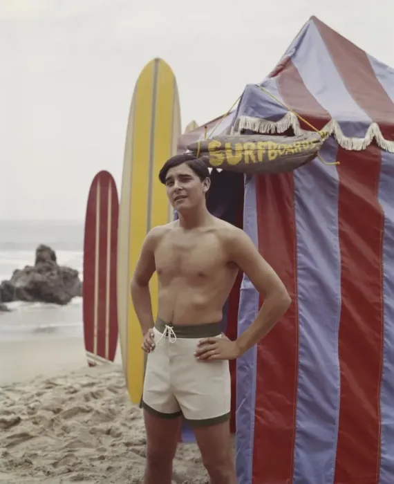 Framed Print : Young man standing beside tent on beach, portrait