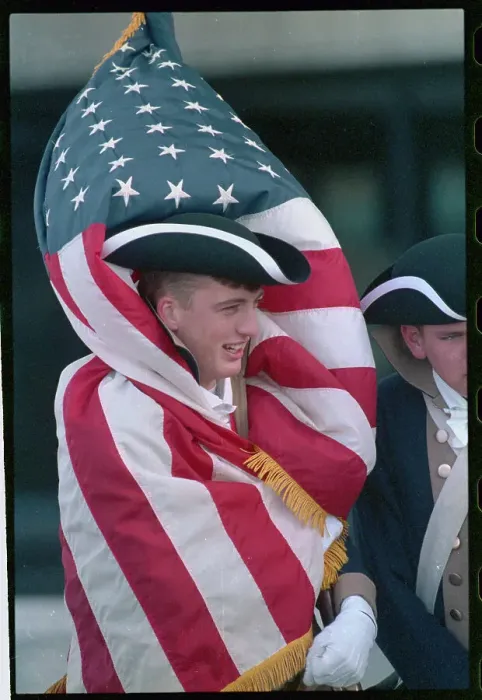 Framed Print : Young Man Wearing American Flag to Keep Warm Framed Print : Young Man Wearing American Flag to Keep Warm