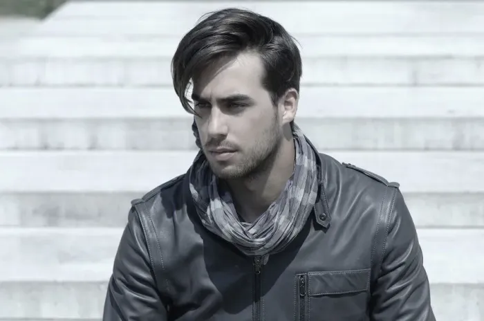 Framed Print : Young man wearing a leather jacket in front of an open staircase, portrait Framed Print : Young man wearing a leather jacket in front of an open staircase, portrait
