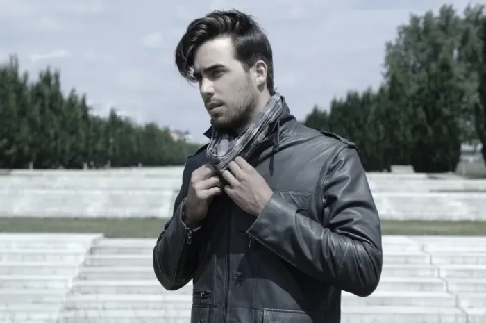 Framed Print : Young man wearing a leather jacket in front of an open staircase, portrait Framed Print : Young man wearing a leather jacket in front of an open staircase, portrait