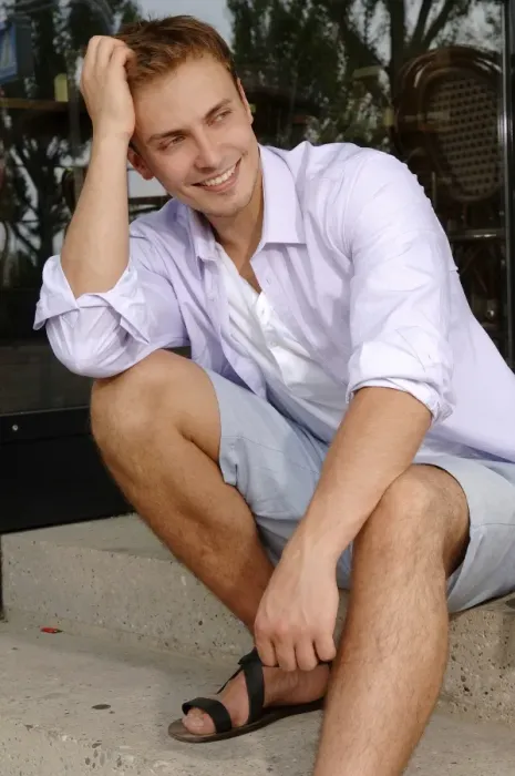 Framed Print : Young man wearing shorts, sitting Framed Print : Young man wearing shorts, sitting