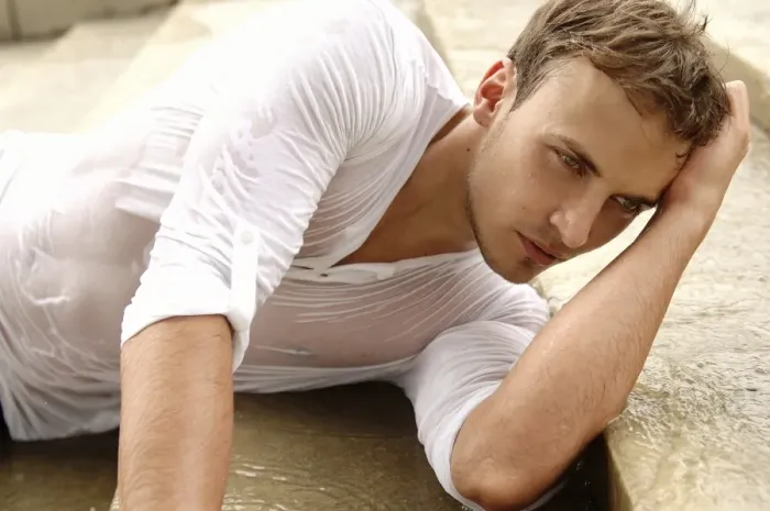 Framed Print : Young man wearing a wet shirt, lying on stairs Framed Print : Young man wearing a wet shirt, lying on stairs
