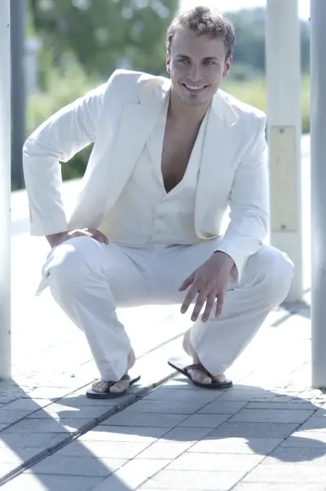 Framed Print : Young man wearing a white suit, smiling Framed Print : Young man wearing a white suit, smiling