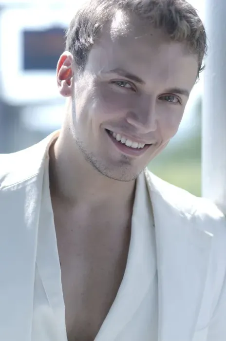 Framed Print : Young man wearing a white suit, smiling, portrait Framed Print : Young man wearing a white suit, smiling, portrait