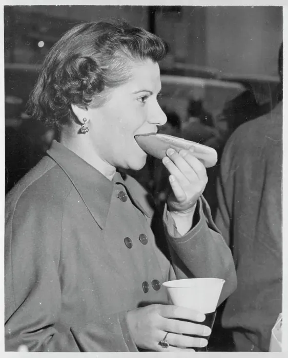Framed Print : Young New York City Woman Eating a Hot Dog with Drink in Hand Framed Print : Young New York City Woman Eating a Hot Dog with Drink in Hand