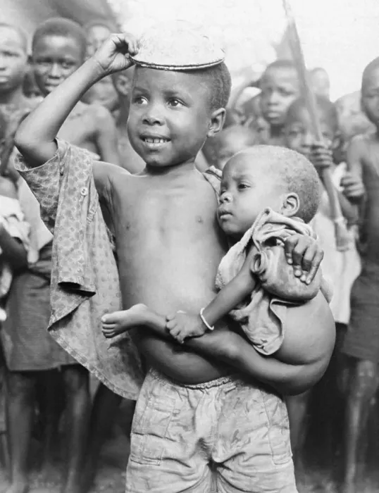 Framed Print : Young Nigerian Boy Smiling and Carrying His Younger Sibling Framed Print : Young Nigerian Boy Smiling and Carrying His Younger Sibling