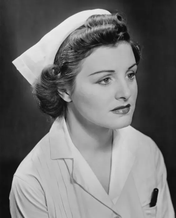 Framed Print : Young nurse sitting, looking away, (B&W)