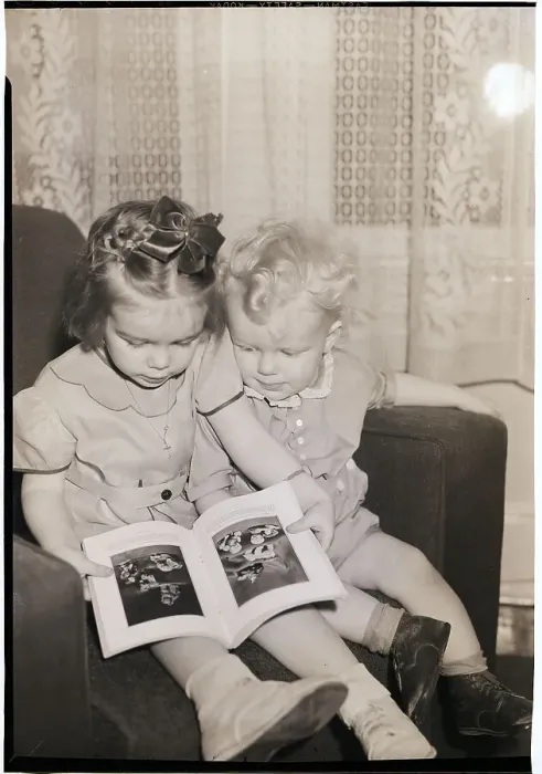 Framed Print : Young Sister and Brother Looking at Book