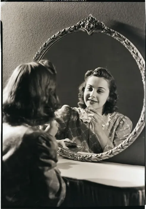 Framed Print : Young Woman Applying Cosmetics Framed Print : Young Woman Applying Cosmetics