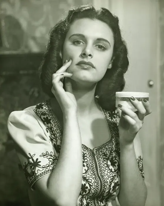 Framed Print : Young woman applying creme on face, (B&W), portrait Framed Print : Young woman applying creme on face, (B&W), portrait