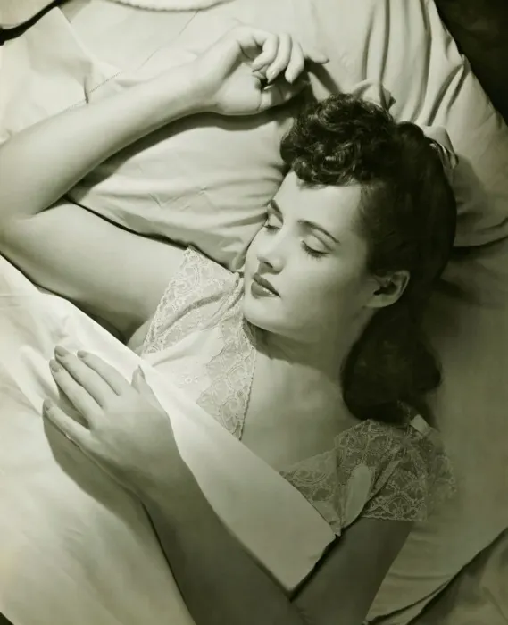Framed Print : Young woman asleep on bed, (B&W), close-up Framed Print : Young woman asleep on bed, (B&W), close-up