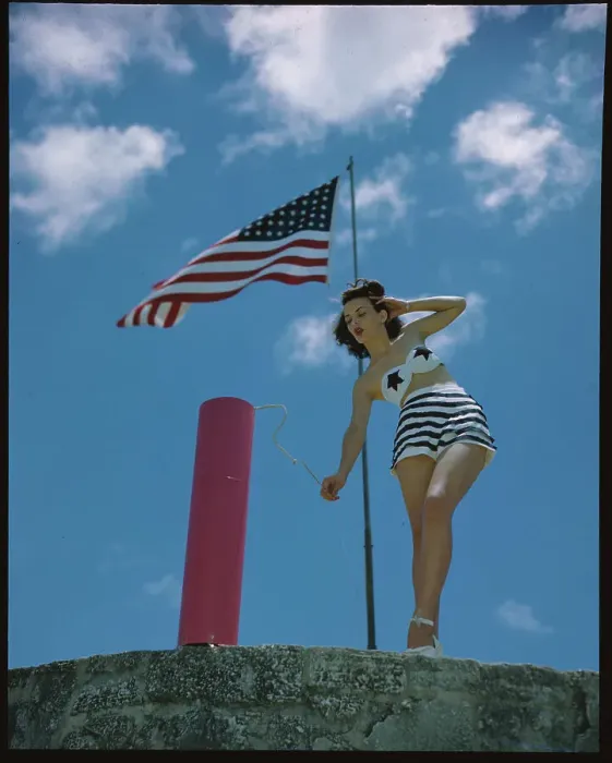 Framed Print : Young Woman in Bathing Suit Lighting Firecracker Framed Print : Young Woman in Bathing Suit Lighting Firecracker
