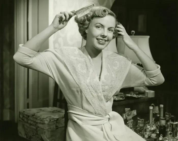 Framed Print : Young woman brushing hair, at home, (B&W), portrait Framed Print : Young woman brushing hair, at home, (B&W), portrait