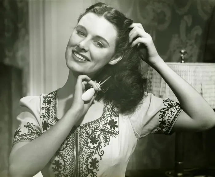 Framed Print : Young woman combing hair, (B&W), portrait Framed Print : Young woman combing hair, (B&W), portrait