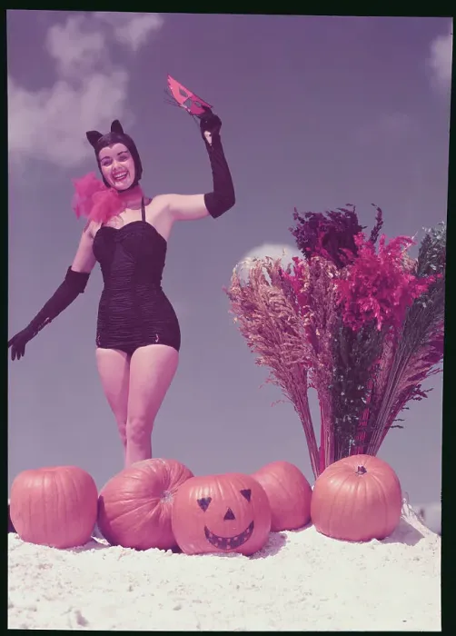 Framed Print : Young Woman in Costume Posing on Beach with Pumpkins Framed Print : Young Woman in Costume Posing on Beach with Pumpkins
