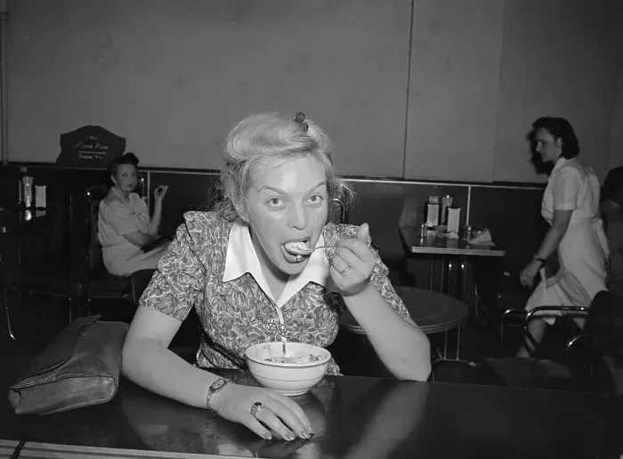 Framed Print : Young woman devouring ice cream dessert Framed Print : Young woman devouring ice cream dessert