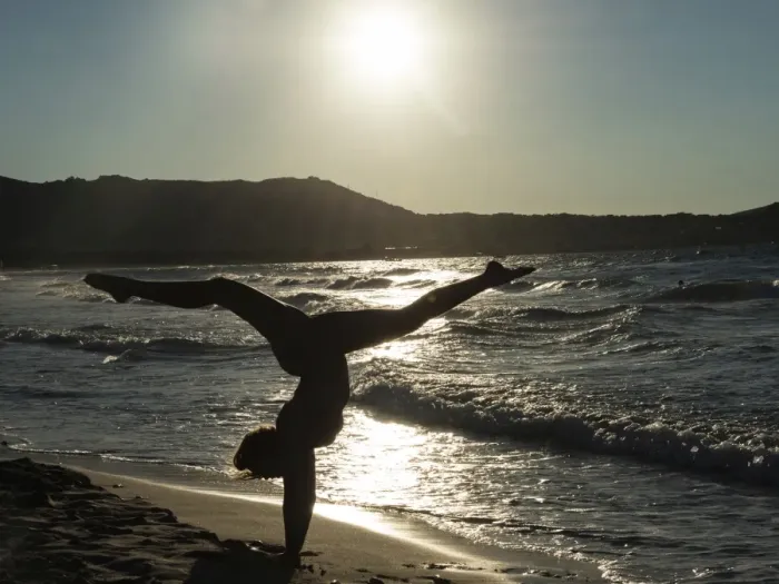 Framed Print : Young woman doing gymnastics on the beach, backlight, Corsica, France Framed Print : Young woman doing gymnastics on the beach, backlight, Corsica, France