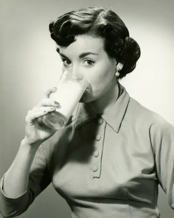 Framed Print : Young woman drinking glass of milk, (B&W), portrait Framed Print : Young woman drinking glass of milk, (B&W), portrait