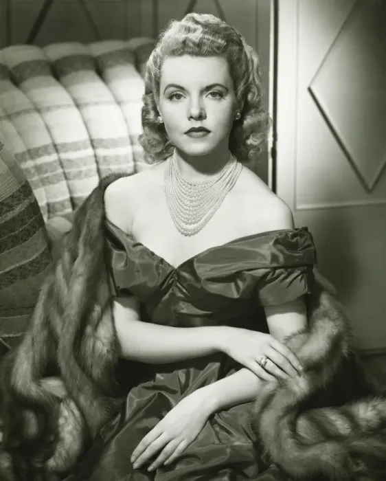 Framed Print : Young woman in evening dress sitting indoors, (B&W), portrait Framed Print : Young woman in evening dress sitting indoors, (B&W), portrait