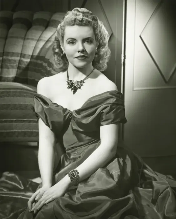 Framed Print : Young woman in evening dress sitting indoors, (B&W), portrait Framed Print : Young woman in evening dress sitting indoors, (B&W), portrait
