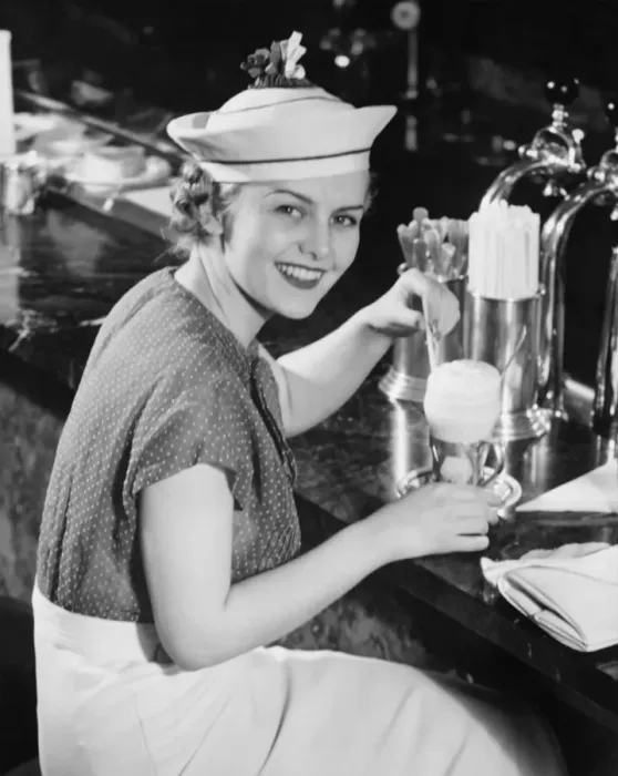 Framed Print : Young woman in fancy hat drinking ice cream soda (B&W), portrait