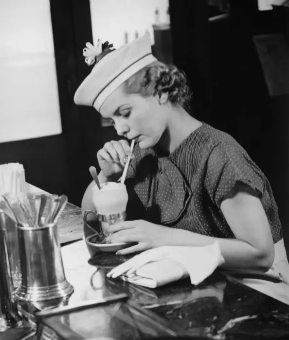Framed Print : Young woman in fancy hat drinking ice cream soda (B&W) Framed Print : Young woman in fancy hat drinking ice cream soda (B&W)