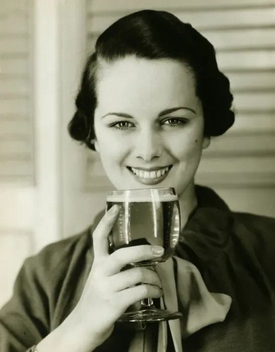 Framed Print : Young woman holding glass of beer, (B&W), portrait Framed Print : Young woman holding glass of beer, (B&W), portrait